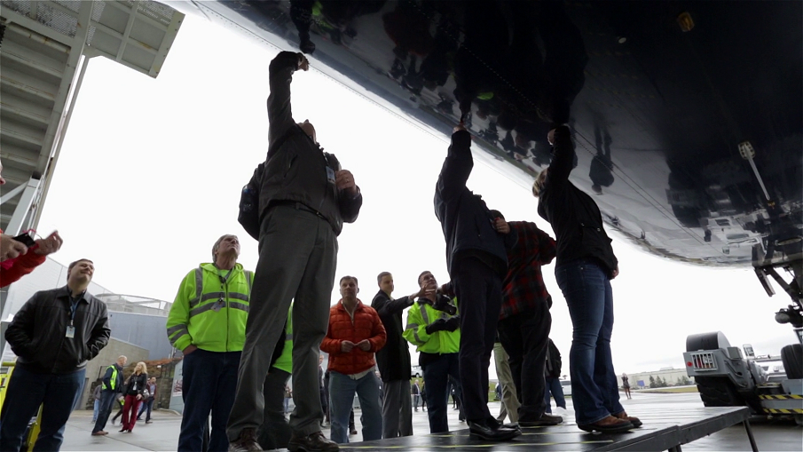 Boeing workers sign the underside of the last Delta Airlines passenger 747.