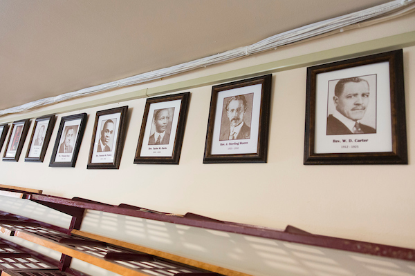Photos of former pastors hang on the wall at Mount Zion Baptist Church in Seattle on Sunday, May 27, 2018. (Photo by Jason Redmond for Crosscut)