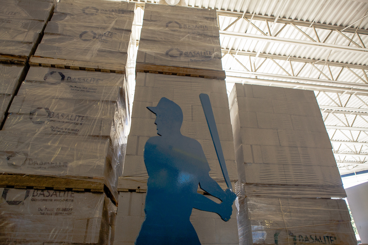 a statue of a baseball player inside the Lowe's Hardware store