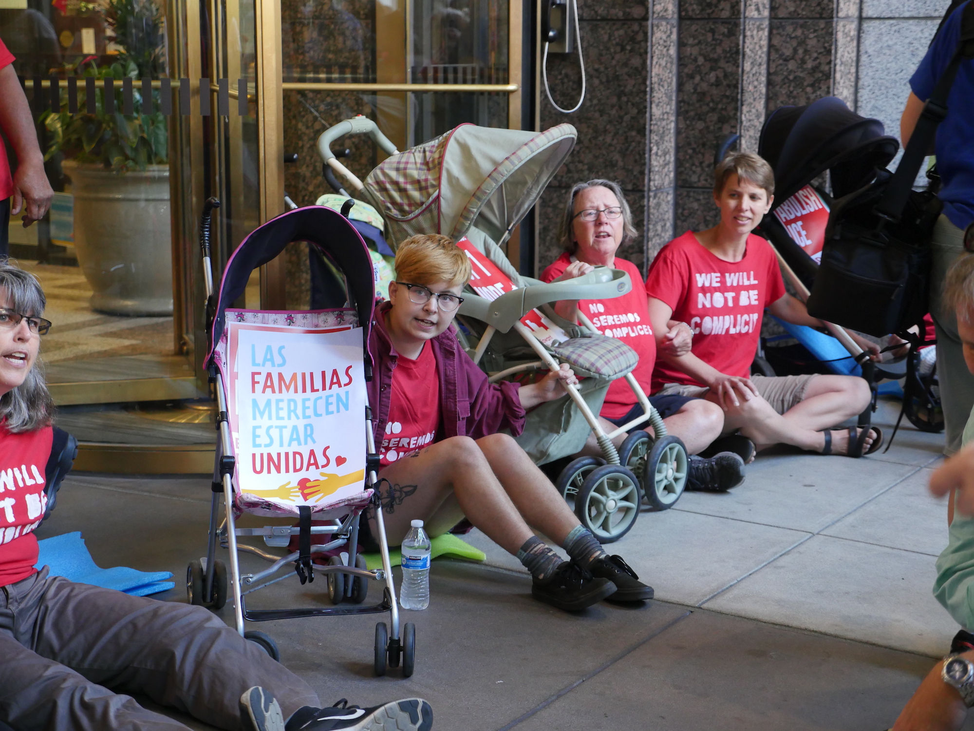 Protestors locked arms in front of ICE's downtown Seattle location to protest the separation of immigrant families, July 26, 2018.  (Photo by Manola Secaira/Crosscut)