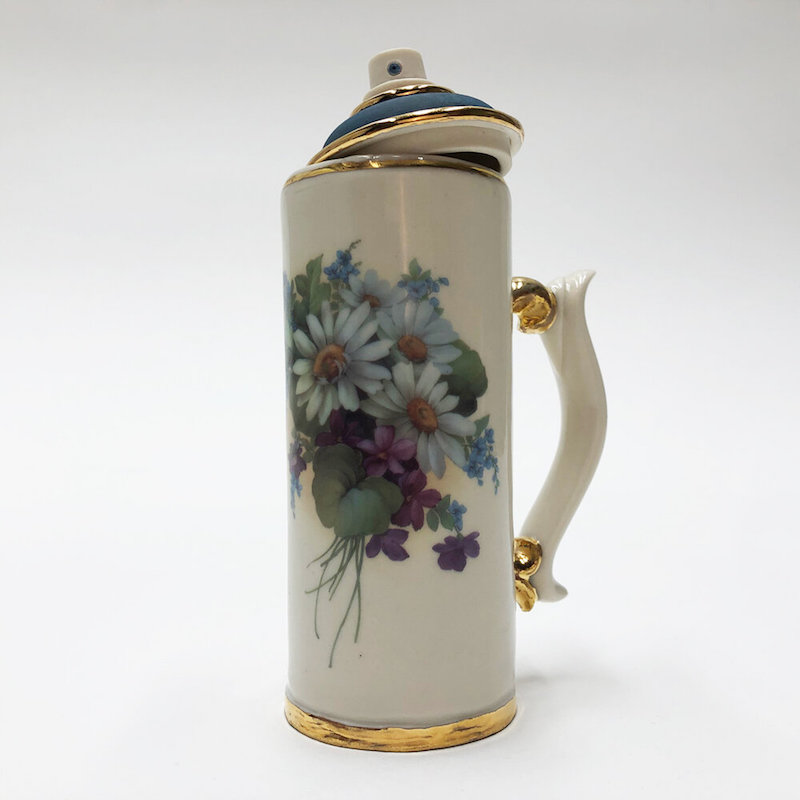 a spray paint can painted to look like a porcelain vase
