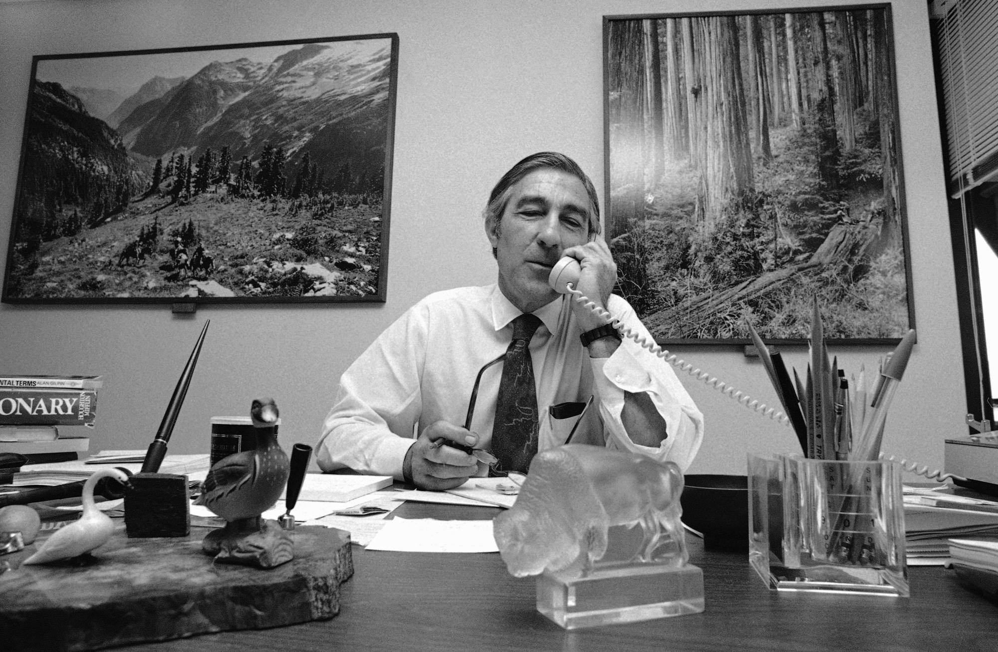 Stewart Udall sits behind the desk in his Washington law office