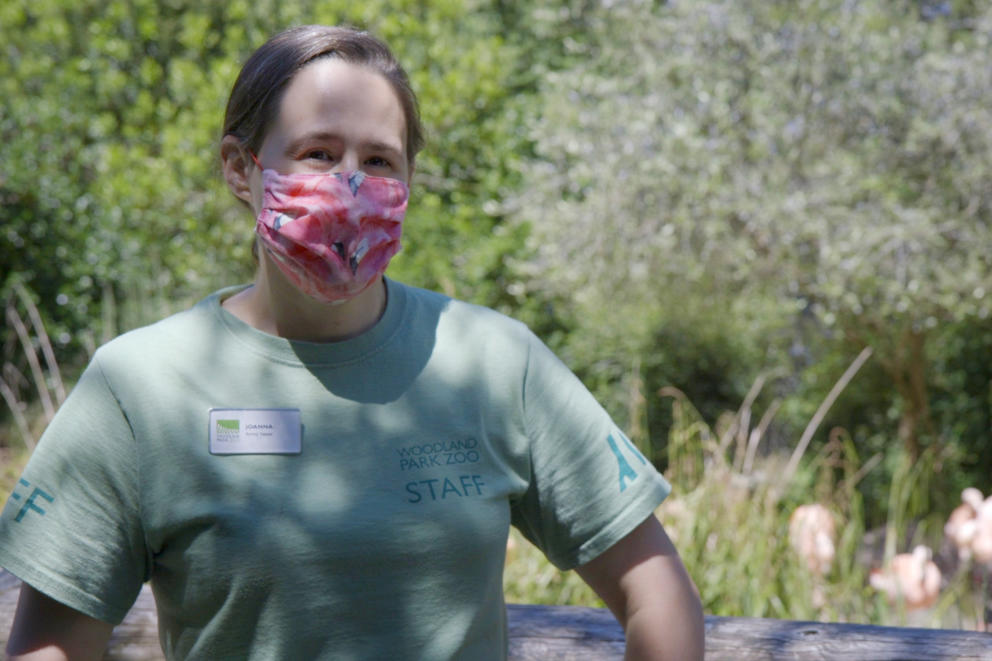 Animal keeper Joanna Klass stands in front of the flamingo habitat at Woodland Park Zoo on May 27, 2020.