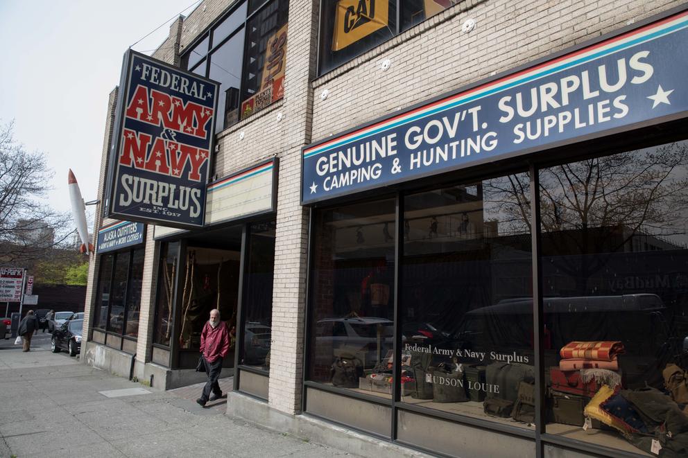 A man walks out the door of the Federal Army & Navy Surplus store in Seattle’s Belltown neighborhood, April 19. 