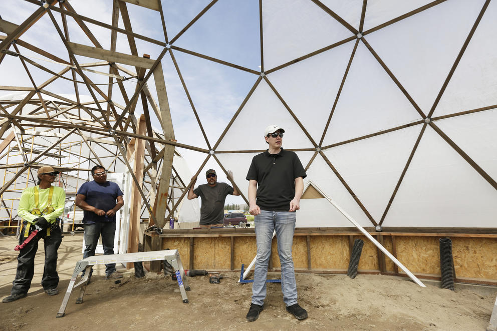 Makoti Fox speaks inside a geodesic dome under construction .