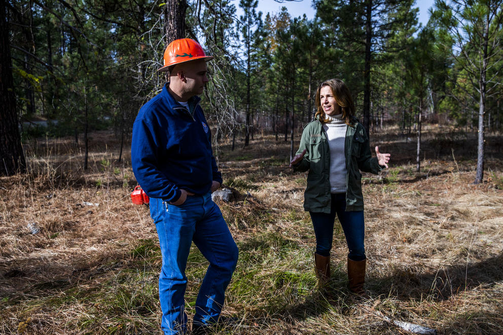 Washington State Lands Commissioner Hilary Franz, right, and Assistant Regional Manager of state lands Larry Leach in the Teanaway Community Forest on Wednesday, Oct. 24, 2018. The Department of Natural Resources is implementing a forest health treatment plan which uses dying forest for cross laminated timber. Franz says this plan will also help keep the cost of wildfire suppression down and make forests more resilient to wildfires. (Photo by Dorothy Edwards/Crosscut)