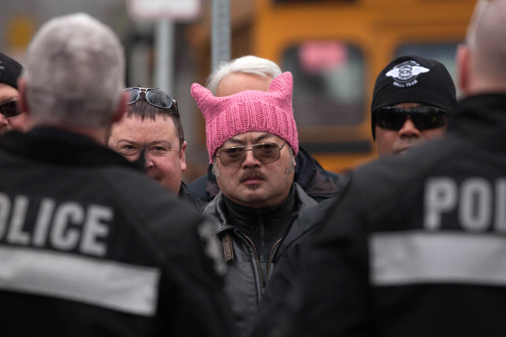 Wearing a pink pussy hat, Seattle Police Department officer K. Lee stages with other officers at Seattle Center at the conclusion of the Seattle Women’s March 2.0 in Seattle, Jan. 20, 2018.