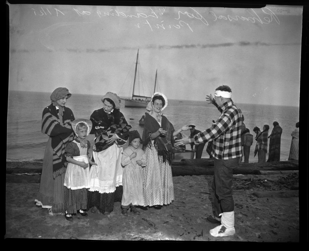 People dressed up as settlers near open water