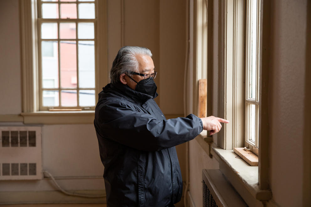 a man points out the window in Seattle's chong wa benevolent association building