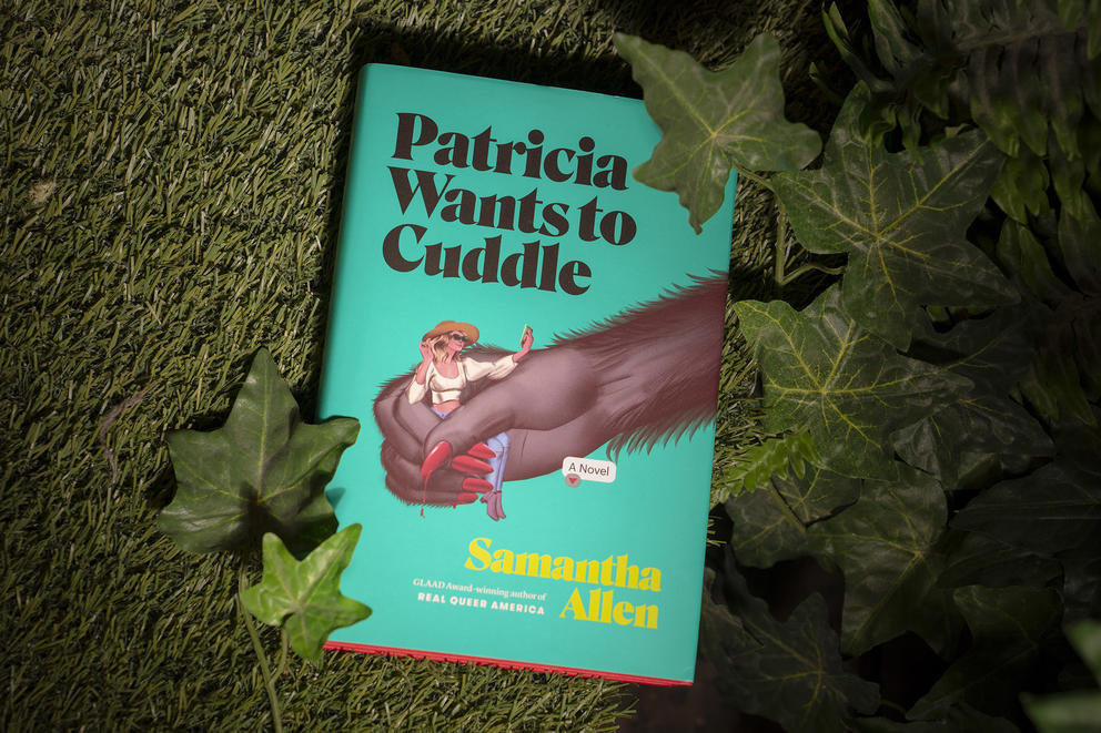 A novel with a green cover featuring a hairy hand holding a woman. The text says in black "Patricia Wants To Cuddle"