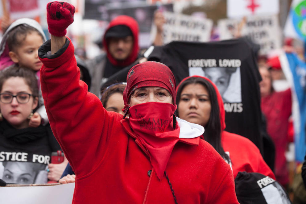 A member of the Murdered and Missing Indigenous Women’s contingent raises her right fist as she leads the Seattle Women’s March 2.0 in Seattle, Jan. 20, 2018.