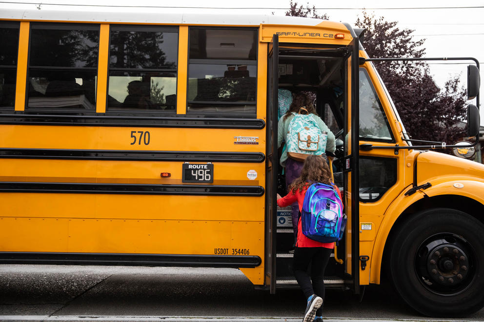 students boarding a school bus