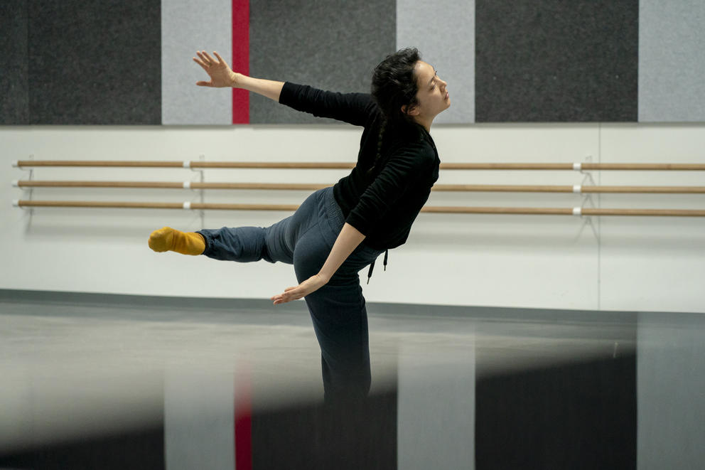A dancer twirls with one leg up behind her and her arms out to her sides