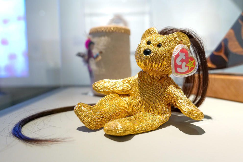 photo of a beanie baby bear embroidered in gold beads