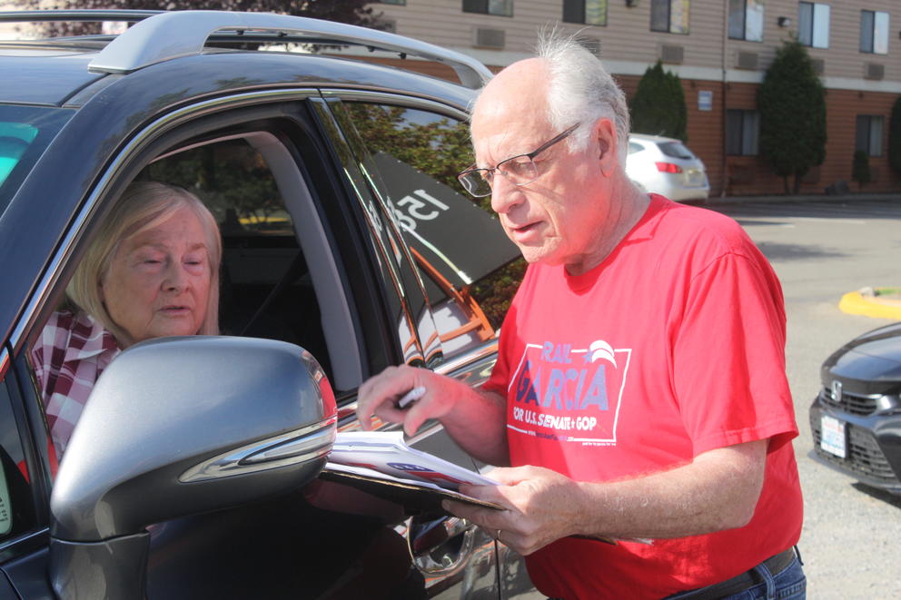 Andy Cilley of Bonney Lake collects signatures in Kent for a petition