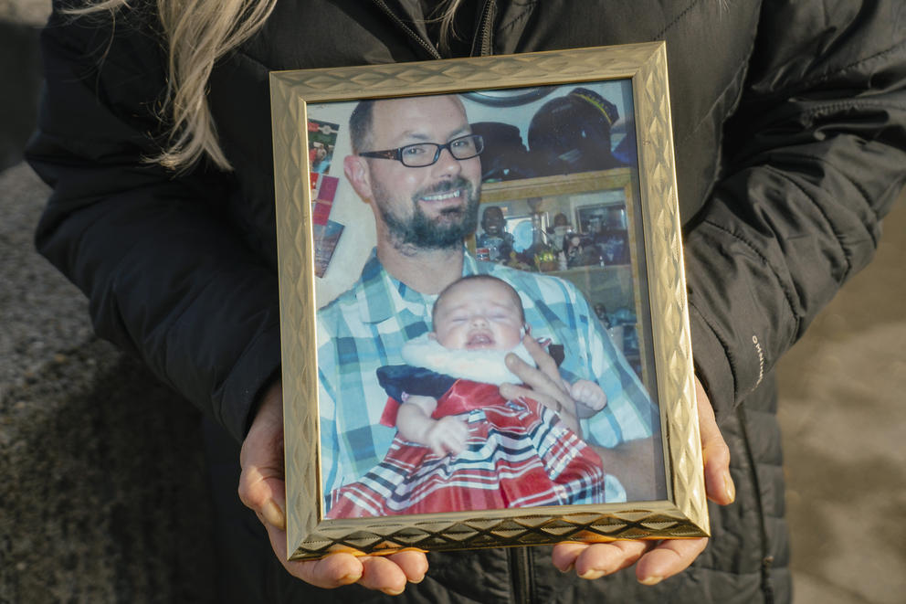 A close up of a framed photograph of a man and a baby.