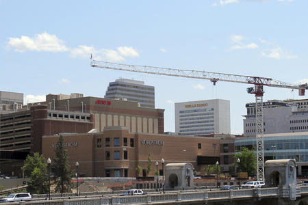 The Spokane city skyline with a construction crane in the foreground.