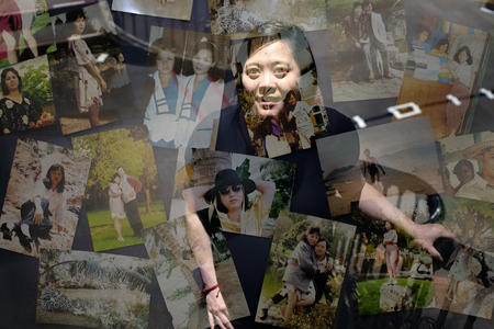 a double exposure image of a woman and a table full of photos