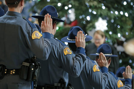 State troopers with hands up at a swearing in ceremony