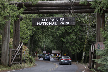 The west entrance to Mount Rainier National Park during busier times, before COVID-19 health concerns brought parks to a standstill. As Washington considers how to re-open the public lands social distancing will remain a priority. (Ted S. Warren/AP)