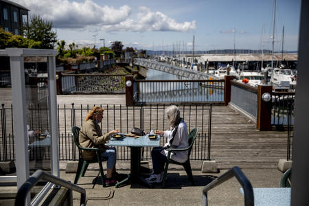 People have lunch together on the patio of Lombardi's Italian Restaurant in Everett