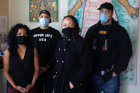 Four political consultants stand together while wearing masks to protect against COVID-19