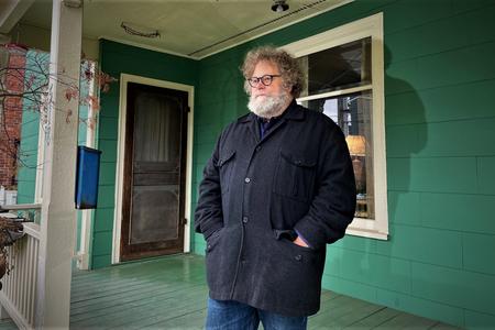Knute Berger stands on the porch of the former Cayton-Revels house