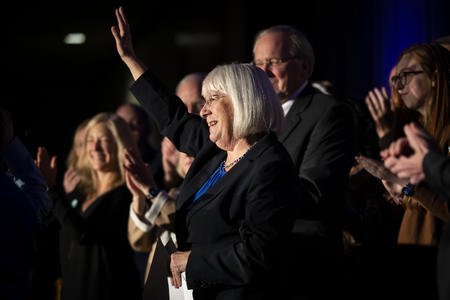 Patty Murray waves surrounded by family
