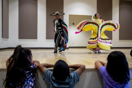 A male and female dancer perform a traditional Mexican dance