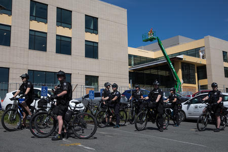 Police officers with bikes standing outside