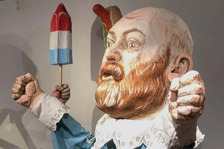 oversized puppet of a bald man with red beard