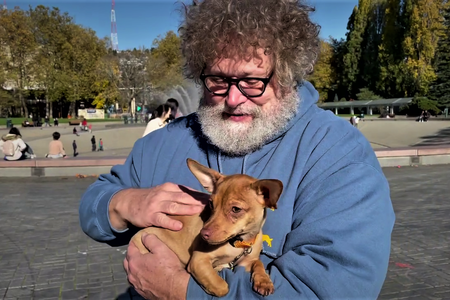 Host Knute Berger holds a dog at Seattle Center