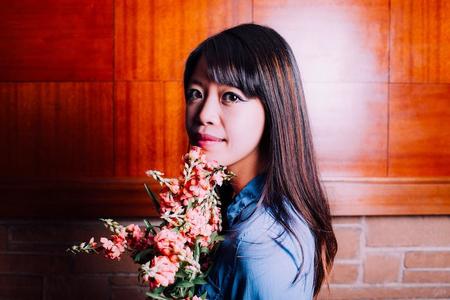 Jane Wong holds a bouquet of flowers
