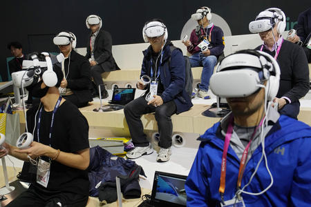Many people sitting, wearing VR headsets
