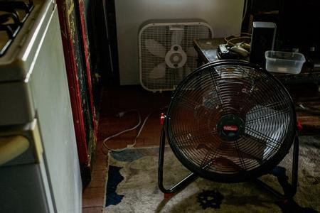 A fan cools the inside of a home during a heatwave.