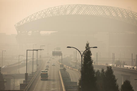 Lumen Field, a sports stadium in Seattle, is visible through haze.