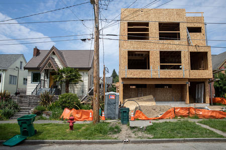 A townhome is being built next to single home housing in Ballard