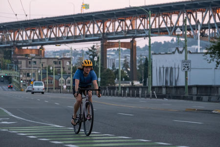 a man rides his bicycle across a bridge in seattle