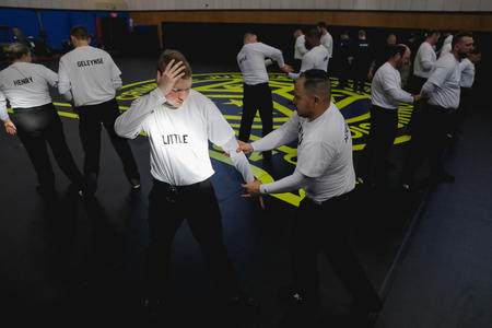 Recruits practice handcuffing techniques at the Criminal Justice Training Center