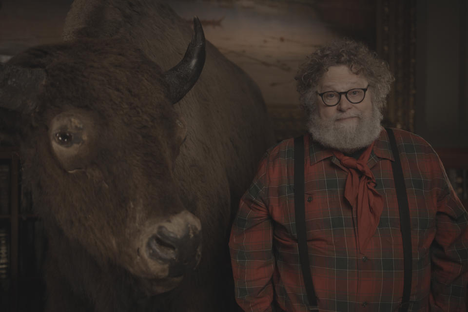 Knute Berger poses with a stuffed buffalo.