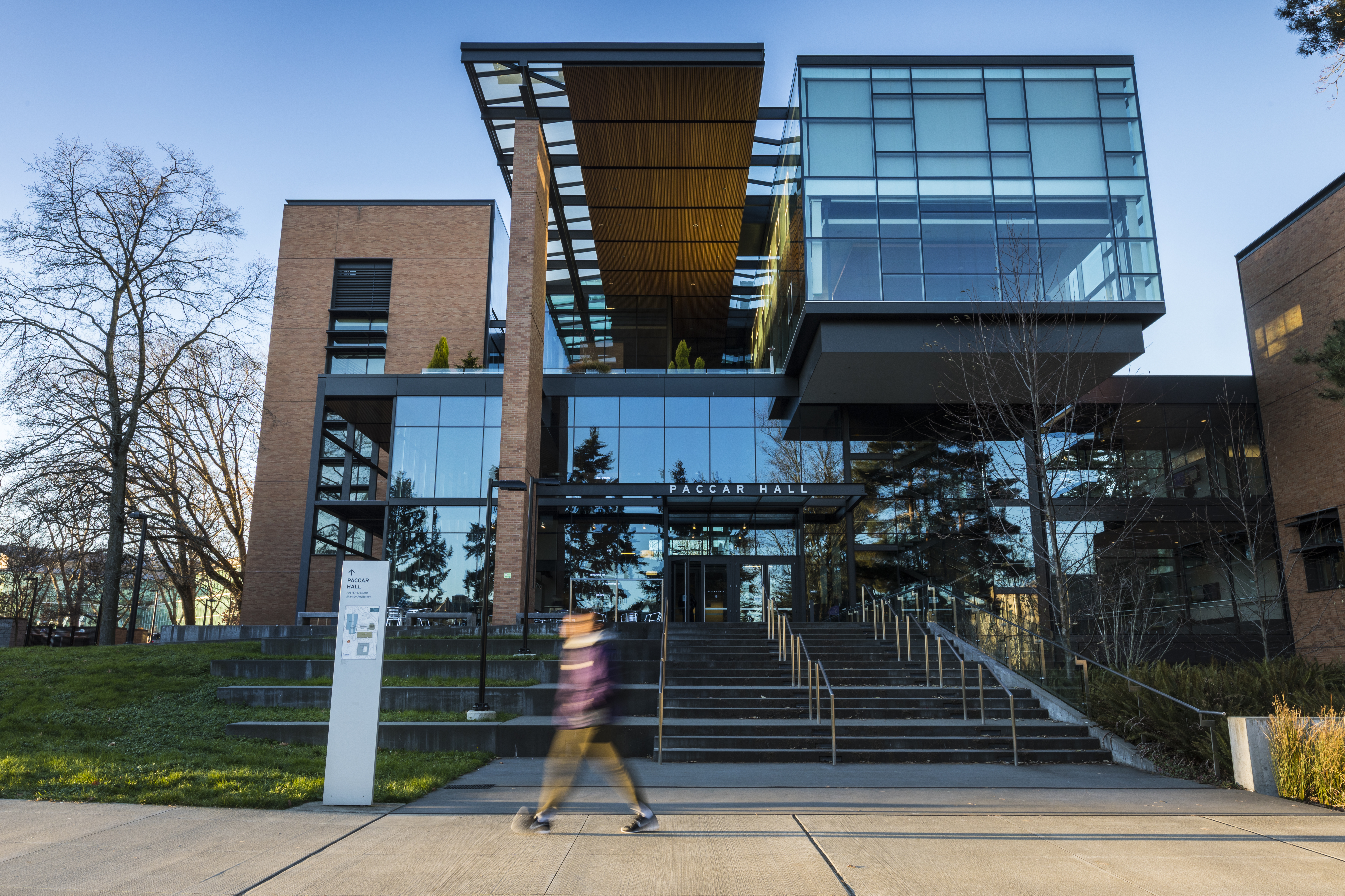 A student walks between Foster School of Business buildings on the University of Washington campus.