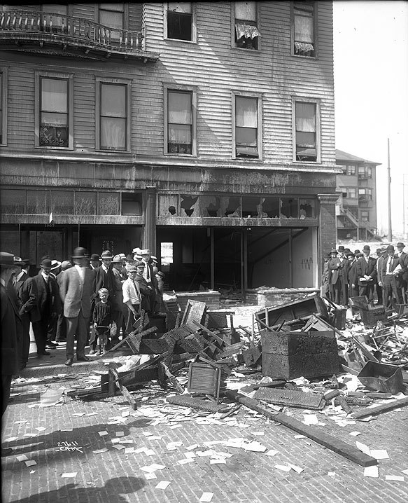 onlookers peer at a destroyed office