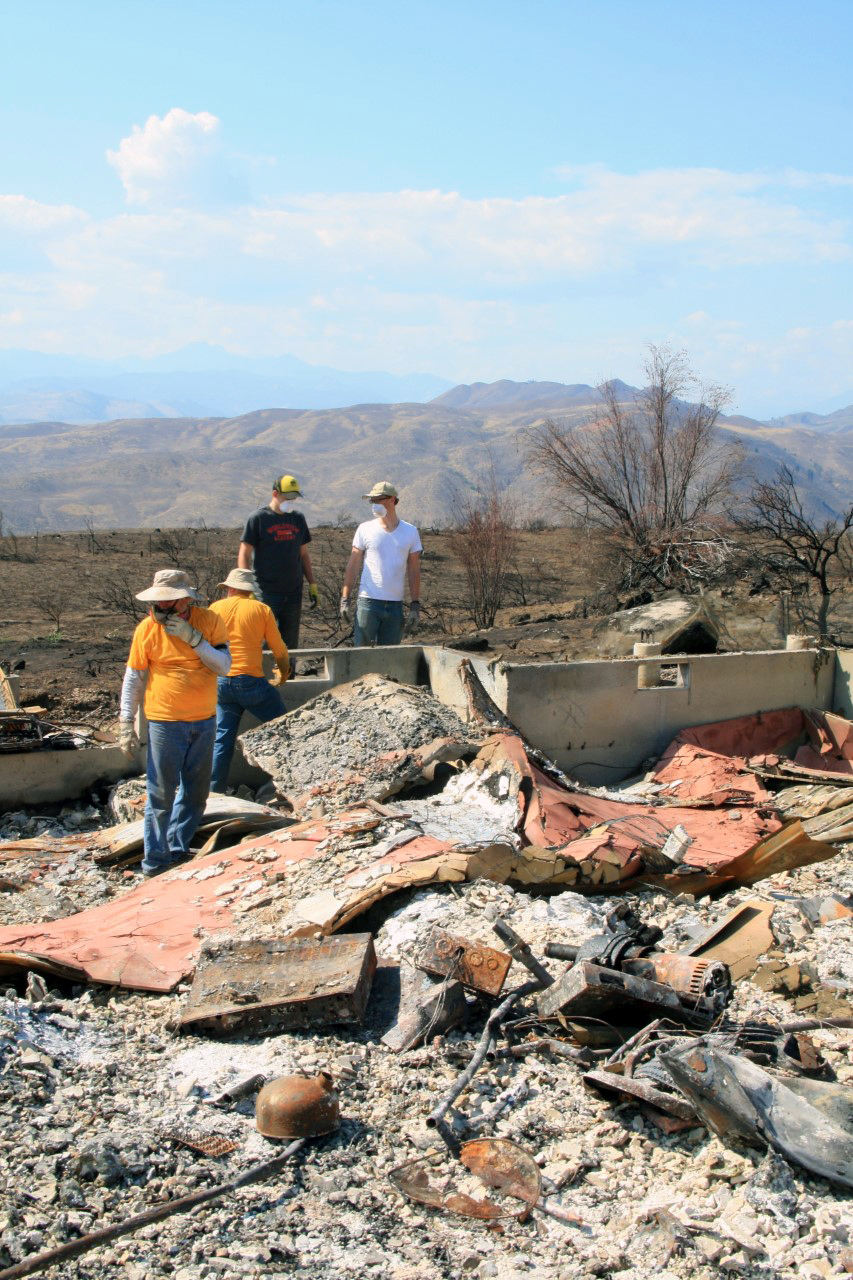 Workers dig through debris