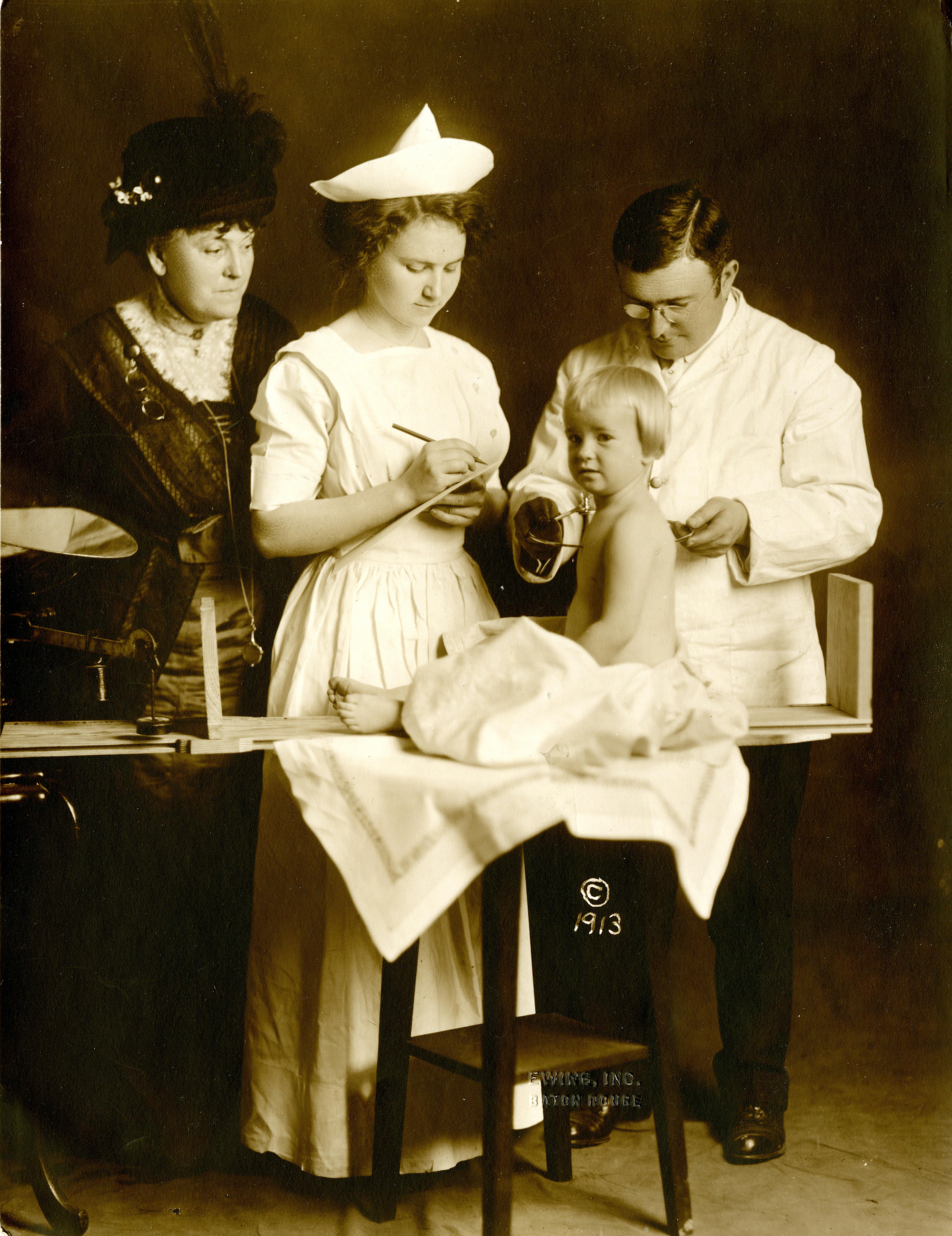 sepia-toned image of a baby with family in doctor's office