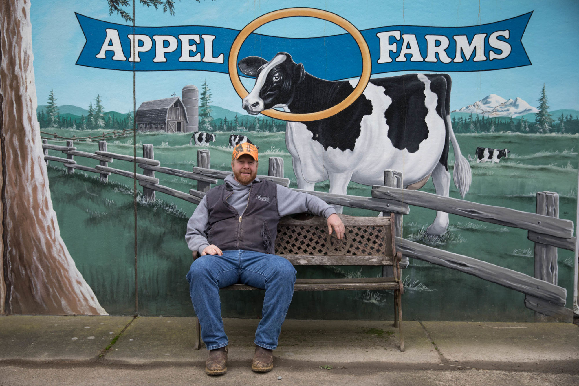 Rich Appel sits in front of a sign for the original cheese plant at Appel Farms near Ferndale, Washington. As their operation has grown over the years, they moved to a larger facility about one hundred yards away, allowing them to produce on a larger scale.