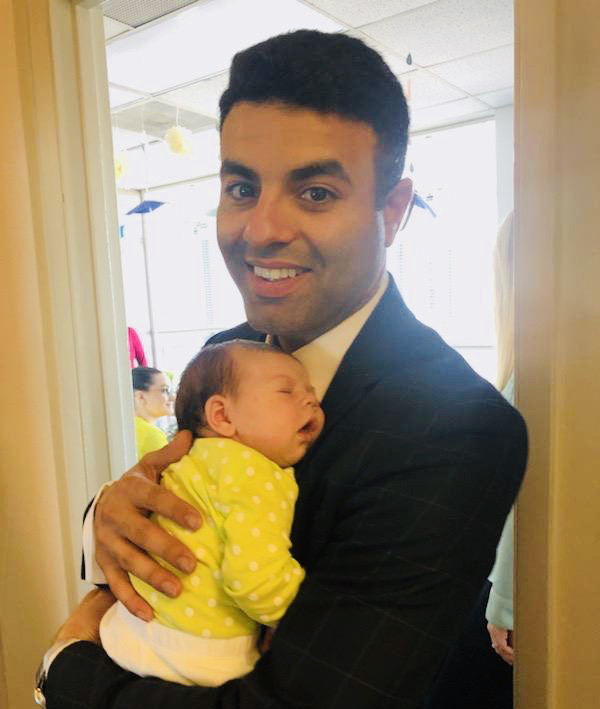 Adam Ballout holding a baby