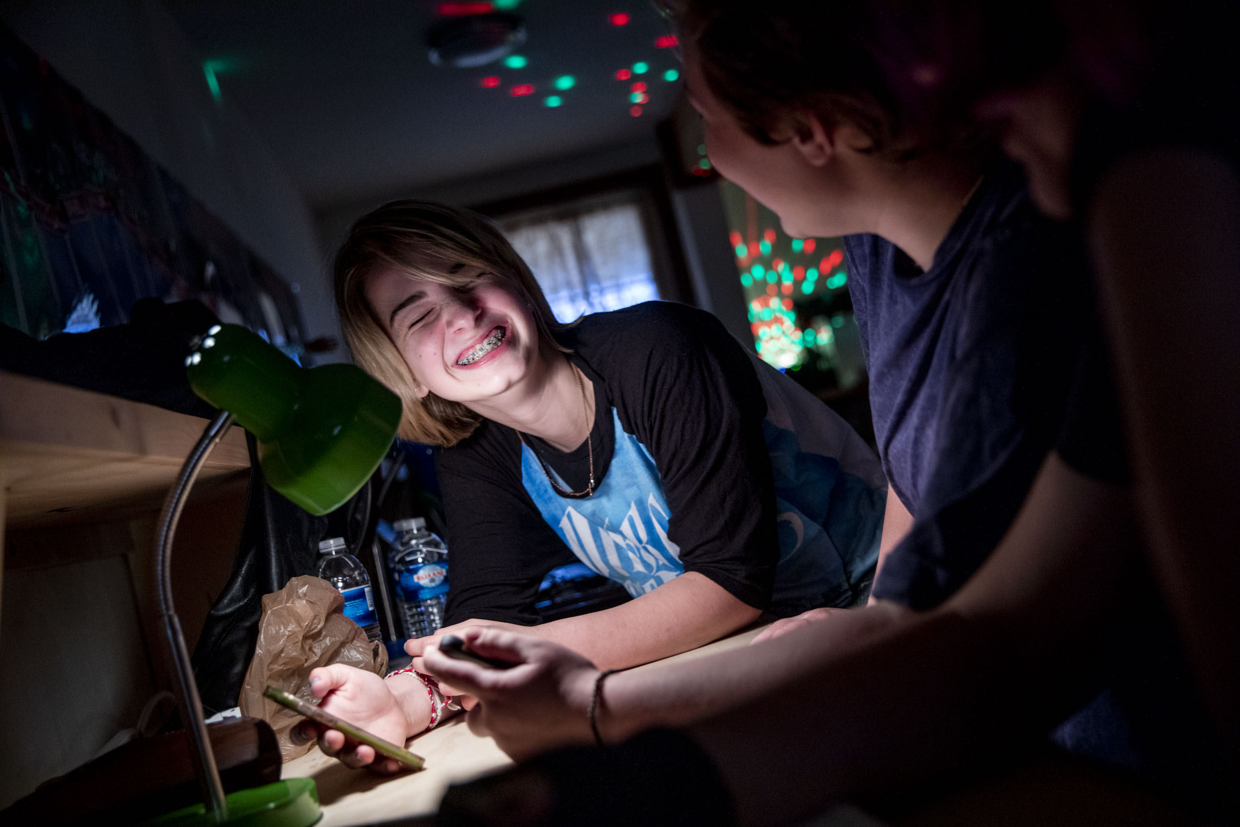 Eighth grader Brooke Benson laughs while playing on her phone during a Nerdy Girls meetup in Ellensburg on May 17, 2019. (Photo by Dorothy Edwards/Crosscut)