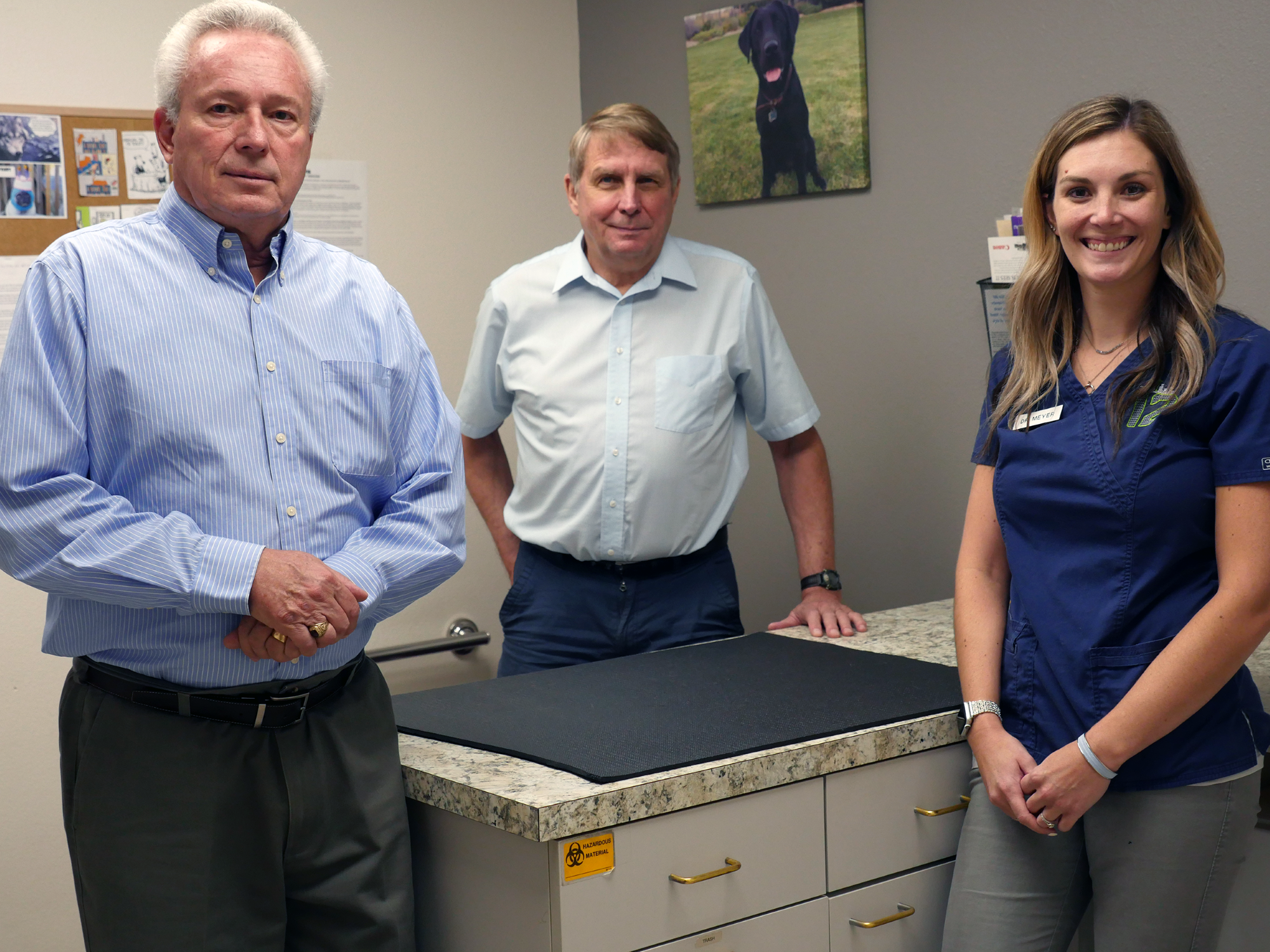 Doctors Fisher, Korenko and Meyer stand inside an animal clinic.