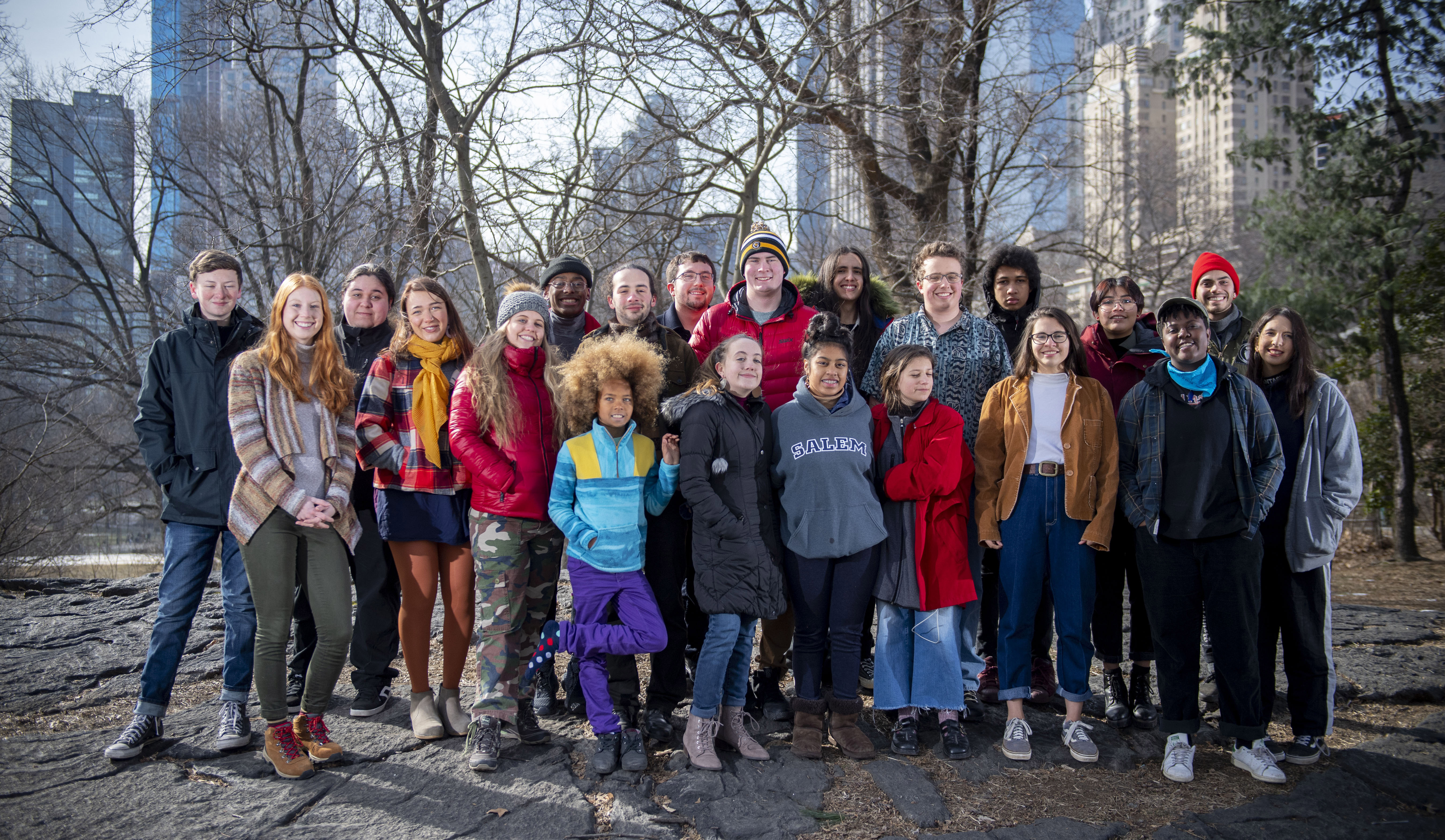 The youth plaintiffs take a photo in Central Park, standing in the park with the city as a backdrop. 