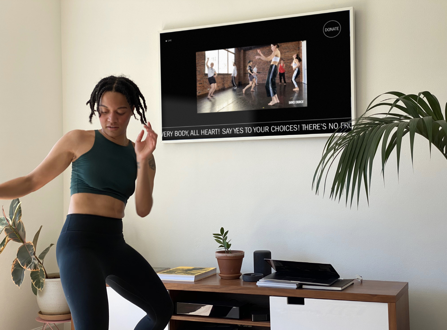 A woman dancing in her living room during a livestream